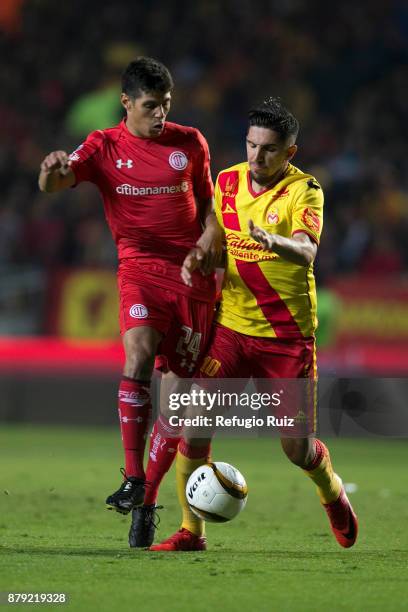 Diego Valdez of Morelia fights for the ball with Pablo Barrientos of Toluca during the quarter finals second leg match between Morelia and Toluca as...