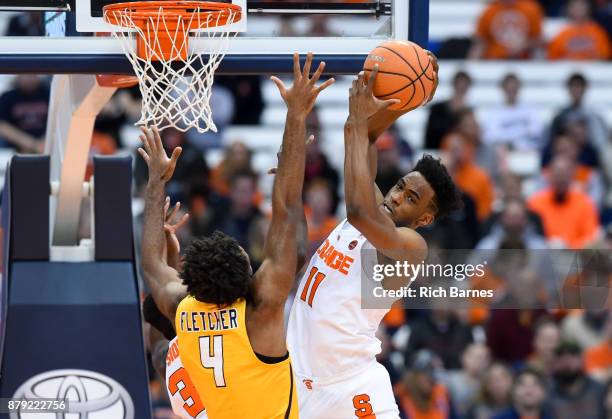 Oshae Brissett of the Syracuse Orange controls a rebound over Tre'Shaun Fletcher of the Toledo Rockets during the first half at the Carrier Dome on...