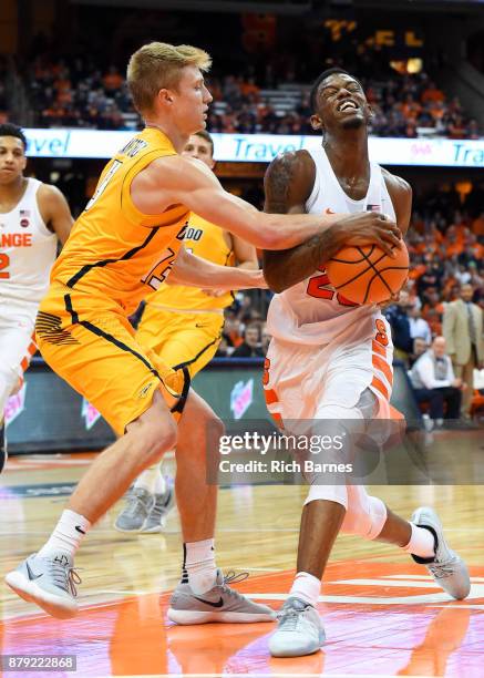 Jaelan Sanford of the Toledo Rockets reaches for the ball as Frank Howard of the Syracuse Orange drives to the basket during the second half at the...