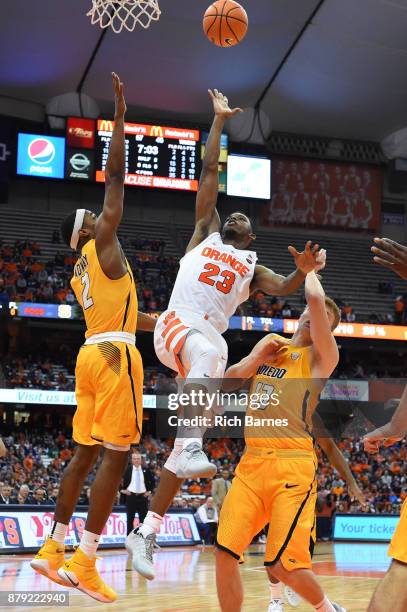 Frank Howard of the Syracuse Orange shoots the ball between Taylor Adway and Jaelan Sanford of the Toledo Rockets during the second half at the...