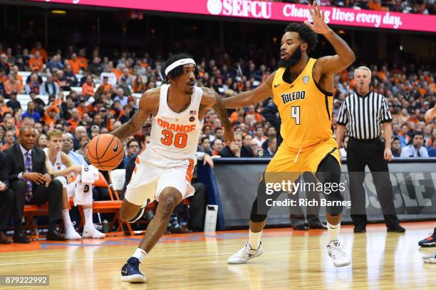 Geno Thorpe of the Syracuse Orange drives to the basket around Tre'Shaun Fletcher of the Toledo Rockets during the second half at the Carrier Dome on...