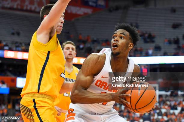 Oshae Brissett of the Syracuse Orange drives to the basket against the defense of Nate Navigato of the Toledo Rockets during the second half at the...