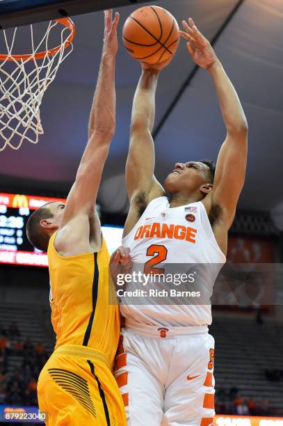 Matthew Moyer of the Syracuse Orange drives to the basket for a shot against the defense of Luke Knapke of the Toledo Rockets during the second half...