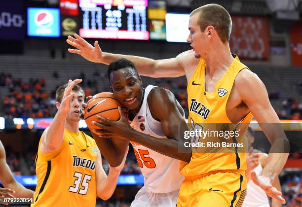 Bourama Sidibe of the Syracuse Orange controls the ball between Nate Navigato and Luke Knapke of the Toledo Rockets during the second half at the...
