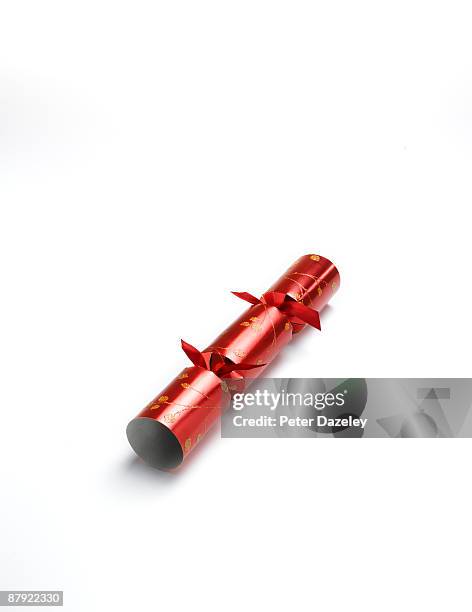 red christmas cracker on white background. - christmas cracker stock pictures, royalty-free photos & images