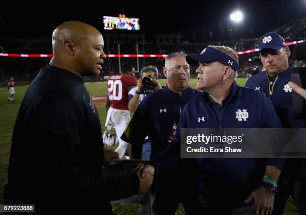 Head coach Brian Kelly of the Notre Dame Fighting Irish shakes hands with head coach David Shaw of the Stanford Cardinal after they game at Stanford...