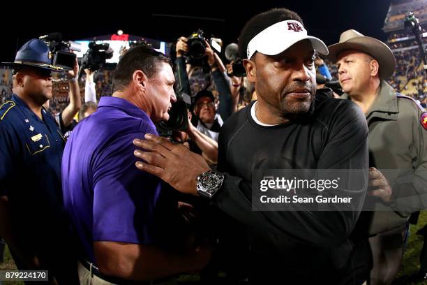 Head coach Kevin Sumlin of the Texas A&M Aggies shakes hands with Head coach Ed Orgeron of the LSU Tigers after his team was defeated by LSU 45 - 21...