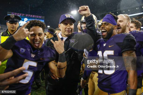 Head coach Chris Petersen of the Washington Huskies celebrates with his team after defeating the Washington State Cougars 41-14 at Husky Stadium on...