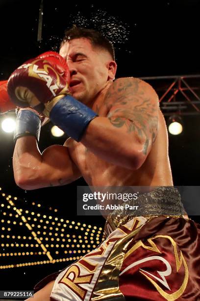 Yuriorkis Gamoba is punched by Jason Sosa during their Junior Lightweights at The Theater at Madison Square Garden on November 25, 2017 in New York...