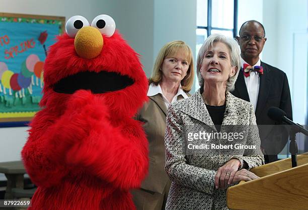 Health and Human Services Department Secretary Kathleen Sebelius and Sesame Street character Elmo watch a PSA Video as Peggy Conlon, CEO of the Ad...