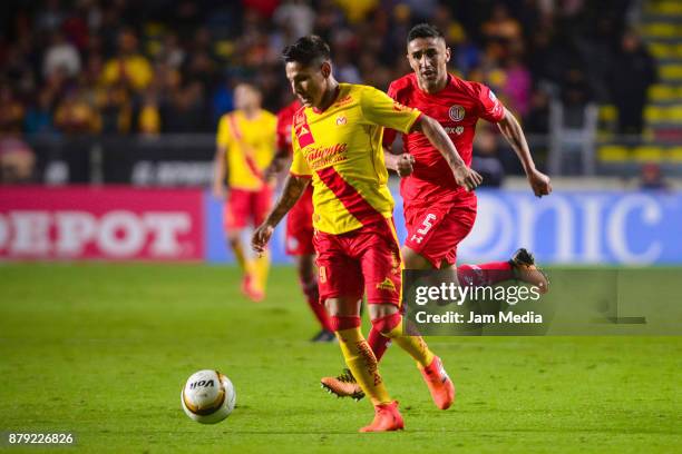 Raul Ruidiaz of Morelia runs with the ball while followed by Santiago Garcia of Toluca during the quarter finals second leg match between Morelia and...