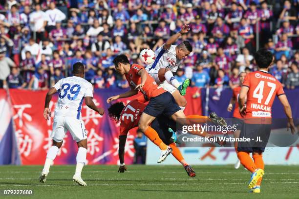 Dudu of Ventforet Kofu competes for the ball against Caue and Kohei Yamakoshi of Omiya Ardija during the J.League J1 match between Omiya Ardija and...