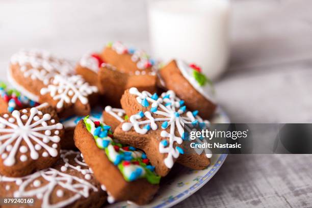 milk and gingerbread cookies decorated with icing - ginger glasses stock pictures, royalty-free photos & images