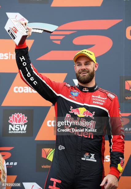 2nd place Shane Van Gisbergen driver of the Red Bull Holden Racing Team Holden Commodore VF celebrates on the podium during race 26 for the Newcastle...