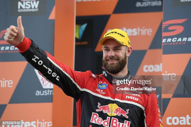 2nd place Shane Van Gisbergen driver of the Red Bull Holden Racing Team Holden Commodore VF celebrates on the podium during race 26 for the Newcastle...