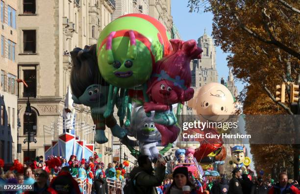 TheTrolls and Charlie Brown balloons floats down Central Park West during the annual Thanksgiving Day Parade on November 23, 2017 in New York City....