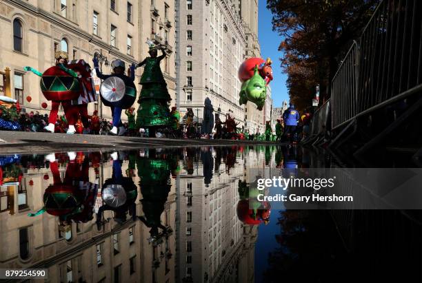 The Grinch balloon floats down Central Park West during the annual Thanksgiving Day Parade on November 23, 2017 in New York City. The Macy's...