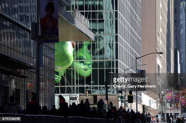 The Grinch balloon floats down 6th Avenue as it crosses 42nd Street during the annual Thanksgiving Day Parade on November 23, 2017 in New York City....