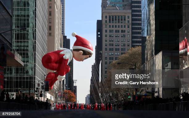 The Elf on a Shelf balloon floats down 6th Avenue as it crosses 42nd Street during the annual Thanksgiving Day Parade on November 23, 2017 in New...