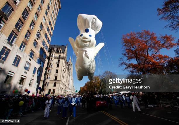 The Pillsbury Doughboy balloon floats down Central Park West during the annual Thanksgiving Day Parade on November 23, 2017 in New York City.