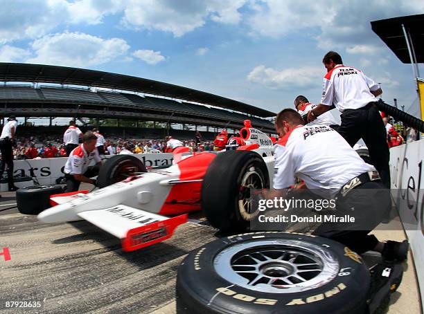 Helio Castroneves, driver of the TEam Penske Dallara Honda, competes to win the Indy 500 Pit Stop Challenge during the Miller Lite Carb Day practice...