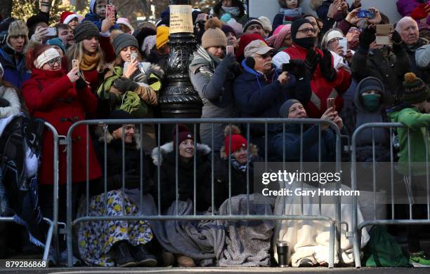 People on Central Park West bundle up to keep warm during the annual Thanksgiving Day Parade on November 23, 2017 in New York City.