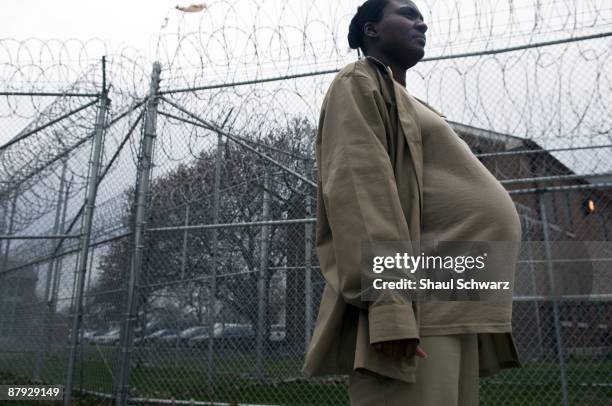 MaShanda Humphrey walks in front of the prison fence on her way to lunch at Indiana Women's Prison on March 24, 2009 in Indianapolis, Indiana. The...