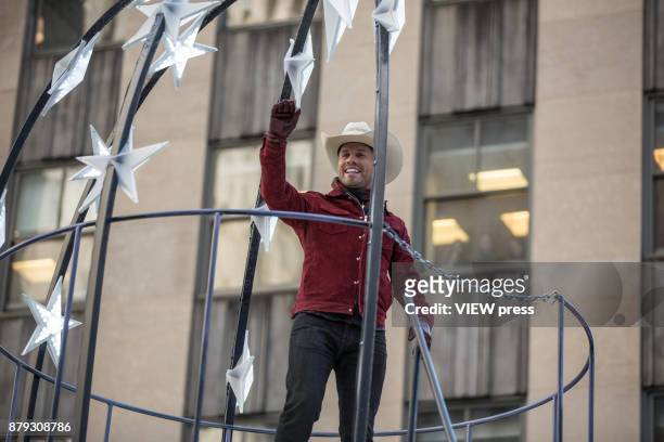 Dustin Lynch waves the people during the 91st annual Macy's Thanksgiving Day Parade on November 23, 2017 in New York City.
