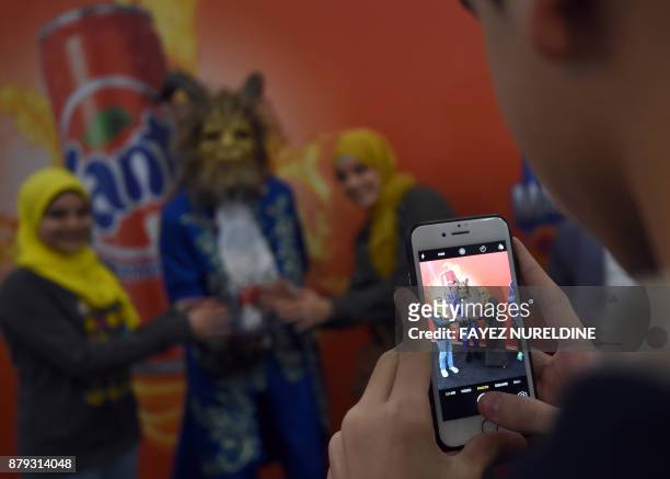 Saudi women pose for a group picture with a cosplayer dressed as the Beast from Disney's 2017 live-action "Beauty and the Beast" film, as they attend...
