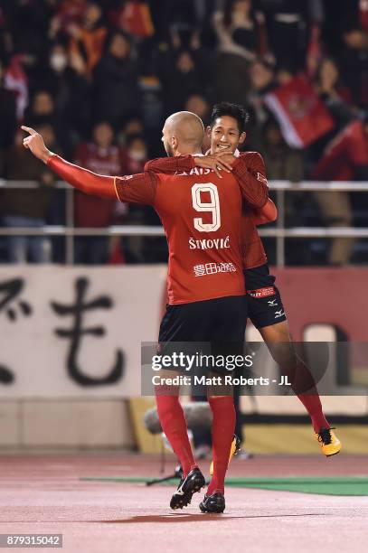 Robin Simovic of Nagoya Grampus celebrates scoring his side's third goal with his team mate Ryota Aoki during the J.League J1 Promotion Play-Off semi...