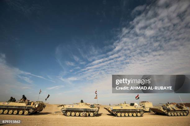 Armoured personnel carriers of the Iraqi forces and the Hashed al-Shaabi are seen during the advance through Anbar province, 20 kilometres east of...