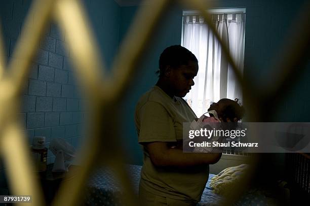 Amanda Lyles holds her baby girl in her prison cell in an Indiana Women's prison in on March 24, 2009 in Indianapolis, Indiana. Indiana Women's...