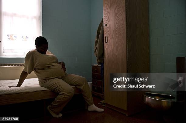 Nancy L. Mays sits on her bed holding her pregnant belly inside her jail cell at the India Women's Prison on March 24, 2009 in Indianapolis, Indiana....