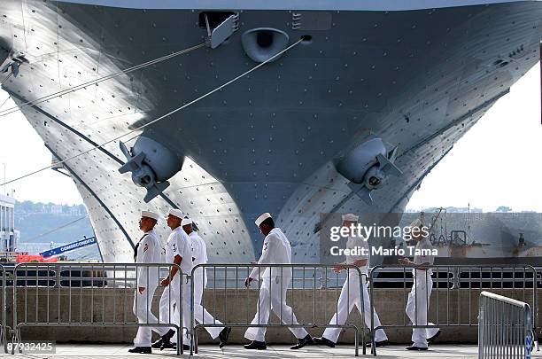 Navy sailors walk past the USS Iwo Jima docked on the Hudson River during Fleet Week May 22, 2009 in New York City. Fleet Week, which annually brings...