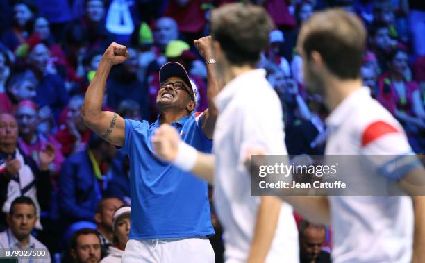 Captain of France Yannick Noah, Pierre-Hughes Herbert and Richard Gasquet of France celebrate winning a point during the doubles match on day 2 of...