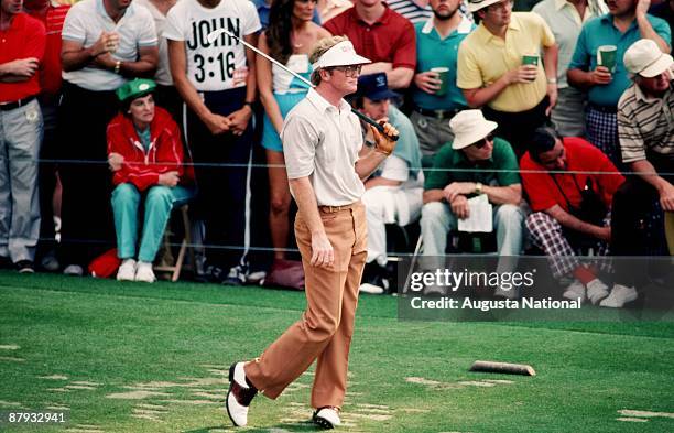 Tom Kite watches his shot off the tee box in front of a small gallery during the 1984 Masters Tournament at Augusta National Golf Club on April 1984...