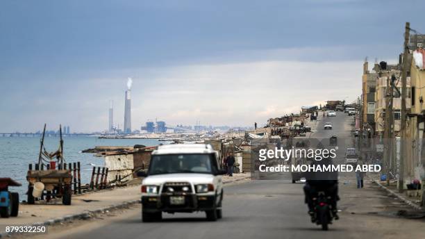 Picture taken on November 24, 2017 shows a general view of a street along al-Shati refugee camp in Gaza City, with the chimneys of the Israeli...