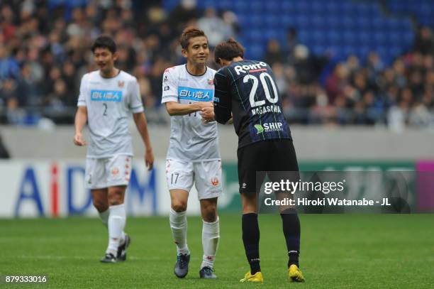 Junichi Inamoto of Consadole Sapporo and Shun Nagasawa of Gamba Osaka shake hands after the J.League J1 match between Gamba Osaka and Consadole...