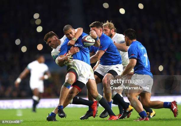 Henry Slade of England tackles Paul Perez of Samoa duirng the Old Mutual Wealth Series between England and Samoa at Twickenham Stadium on November...