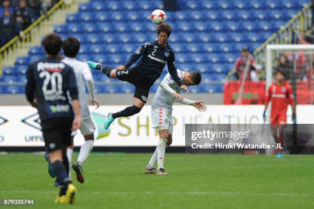 Genta Miura of Gamba Osaka and Jay Bothroyd of Consadole Sapporo compete for the ball during the J.League J1 match between Gamba Osaka and Consadole...