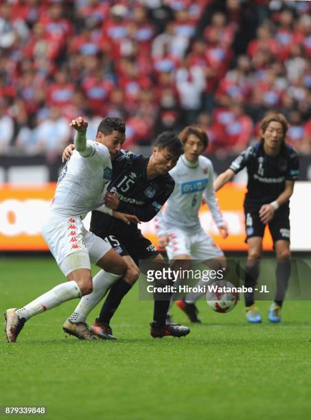Jay Bothroyd of Consadole Sapporo controls the ball under pressure of Yasuyuki Konno of Gamba Osaka during the J.League J1 match between Gamba Osaka...