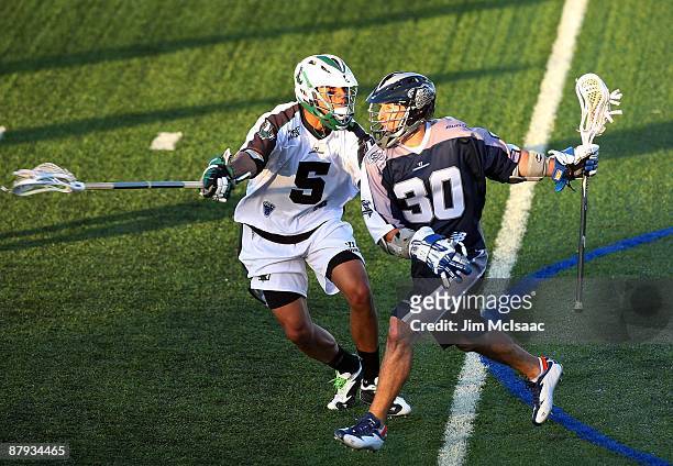 Julian Watts of the Long Island Lizards defends against Scott Urick of the Washington Bayhawks during their Major League Lacrosse game on May 21,...