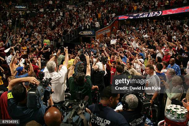 LeBron James of the Cleveland Cavaliers leaves the court amidst a crowd of fans after his last second three pointer wins the game agsinst the Orlando...