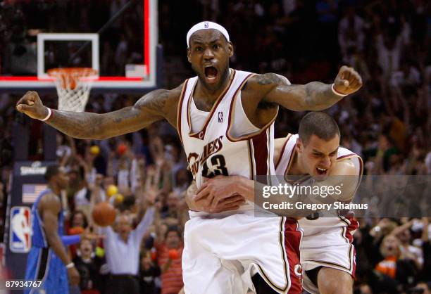 LeBron James and Sasha Pavlovic of the Cleveland Cavaliers celebrate after James made the game winning three pointer against the Orlando Magic in...