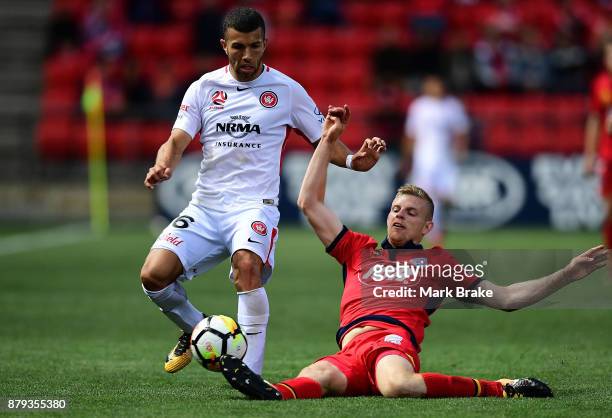 Jaushua Sotirio of West Sydney Wanderers tackled by Ryan Kitto of Adelaide United during the round eight A-League match between Adelaide United and...