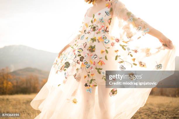 boho lady in a white romantic dress outdoors - floral pattern dress stock pictures, royalty-free photos & images
