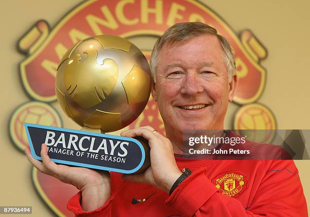 Sir Alex Ferguson of Manchester United poses with his Barclays Manager of the Season award at Carrington Training Ground on May 23 2009 in...