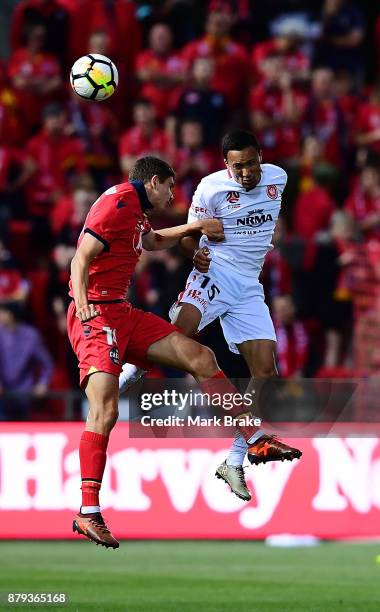 Kearny Baccus of West Sydney Wanderers heads over Karim Matmour of Adelaide United during the round eight A-League match between Adelaide United and...