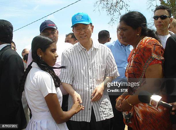United Nations Secretary General Ban Ki-moon shakes hands with a war-displaced Sri Lankan girl during his visit to the state-run Menik Farm refugee...