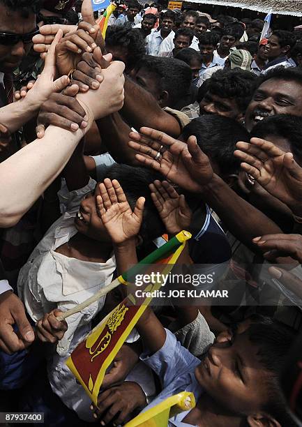 Hand of U.N. Secretary-General Ban Ki-moon is shown greeting Sri Lankan internally displaced people as he visits Menik Farm refugee camp in Sri Lanka...